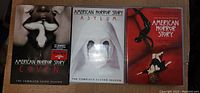 Photo showing three DVD sets for American Horror Story Seasons 1 (Murder House), 2 (Asylum), and 3 (Coven) with visible cover art.