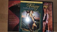 Three DVDs including American Girl Felicity, Neferiti Resurrected 2, Living with Tigers