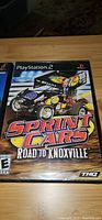 PlayStation 2 game case for Sprint Cars: Road to Knoxville showing front cover artwork with sprint car and logos.