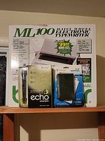 Box and items: Brother ML100 typewriter box, Echo Smartpen in packaging, Pulse File Notepad in packaging.