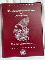 Front cover of the maroon hardcover binder titled The Official Birds and Flowers of Our Fifty States First Day Cover Collection