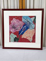 Full view of the framed flower collage, showing the wood-tone frame, matting, and colorful floral paper collage inside.