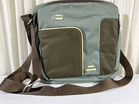 Full front view of the gray and brown waterproof shoulder tote bag with adjustable strap, front zippered compartments, and T Tech logo.