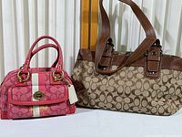 Two purses displayed together: small pink Coach handbag on left, larger brown purse on right.