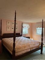 Overall view of king size four poster bed frame with mattress