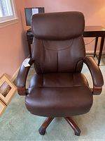 Front view of brown La-Z-Boy leather office chair showing seat, back, armrests and wooden base