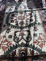 Close-up of central field showing ivory background with geometric and floral motifs