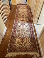 Full length of the rug runner laid in a hallway, showing the overall design and colors.