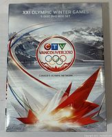 Outer packaging of the XXI Olympic Winter Games Vancouver 2010 5-disc DVD box set showing official logos and winter mountain imagery.