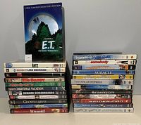 Full view of 24 family DVD movies stacked in two columns with E.T. Limited Edition DVD on top.