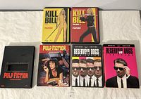 All six Quentin Tarantino DVDs displayed showing front covers: Kill Bill Volumes 1 & 2, two Pulp Fiction editions, two Reservoir Dogs editions.