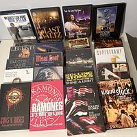 Photo showing the full set of 22 rock music DVDs arranged side by side with visible titles and covers, some unopened.