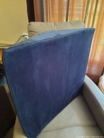 Side view of the first blue wedge cushion showing flat and angled surfaces