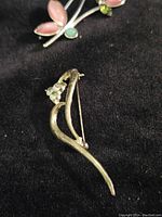 Backside view of pink enamel petal brooch showing pin mechanism and condition.