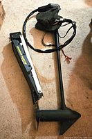 Motor assembly with mount bracket and shaft laid out on carpet