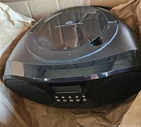 Black Insignia portable radio/CD player with visible CD compartment and control buttons on front