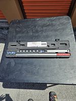 Top-down view of the complete contents layout inside the case, showing all 13 pieces including sockets, wrenches, and other attachments.