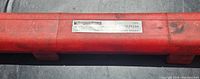 Red plastic case with metal label showing 'Signet' brand and torque wrench specifications 10-150 ft-lbs 3/8 drive.