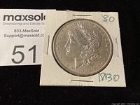 Front view of 1883 O Morgan silver dollar coin in cardboard holder marked "30"