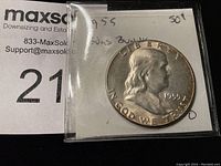 Front obverse view of 1955 Ben Franklin half dollar in plastic sleeve with handwritten label noting '1955 Bugs Bunny 50¢'