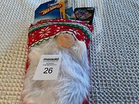 Christmas stocking with Santa face design filled with various small toys inside.