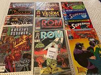 Comic book collection showing 12 comic books including Shadow, Blazer, Venom, ROM Spaceknight, Superman, and Detective Comics Batman.
