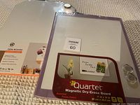 Photo showing the two dry erase boards side by side, with one Quartet magnetic dry-erase board and one GEM Board whiteboard visible in packaging.