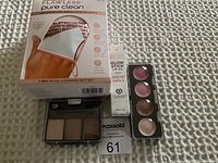 Photo of the boxed Flawless Pure Clean cleansing mitt set with a Pacifica lip oil stick, makeup lip palette, and neutral eyeshadow palette on a textured white surface.