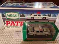 Photo of the 1993 Hess Patrol Car box with the 2003 Miniature Hess Patrol Car in display case positioned in front of the box.