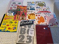 Sticker sheets with various animated and animal designs alongside a sheet of glitter alphabet and number stickers and Dr. Seuss sticker book.
