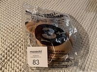Photo of Taco Bell Talking Chihuahua plush toy sealed in original clear plastic packaging. Age recommendation 3+ visible on bag.