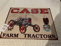 Front view of the rectangular CASE Farm Tractors reproduction tin sign showing detailed tractor image, eagle emblem, and CASE branding with vintage styled distressed background.