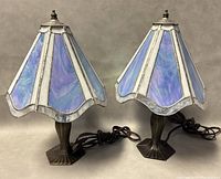 Pair of 16 inch stained glass table lamps with iridescent purple and white glass shades and bronze-tone bases, cords visible