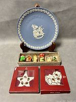 1996 Wedgwood Christmas plate displayed on stand, box of six assorted handcrafted Christmas ornaments, two Royal Albert bone china Christmas ornaments in original boxes (star and boot shapes)