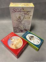 Photo showing three vintage tarot and oracle card decks in their original boxes including Shadowscapes Tarot, Wisdom of the Oracle, and Witchlings.