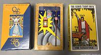 Three vintage tarot card box sets in original boxes placed side by side showing front covers.