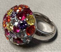 Close-up photo of the silver cocktail ring featuring multicolored crystals on the dome top.