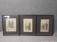 Photo showing all three framed antique architectural prints: Notre-Dame Cathedral, interior courtyard, Arc de Triomphe.
