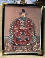 Full view of the framed print showing the Chinese emperor sitting on a throne in traditional attire.
