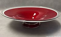 Top view of the red blown glass pedestal bowl showing wide round open shape and glossy finish.