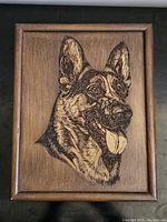 Full view of wooden plaque with carved German Shepherd dog head showing entire framed piece.