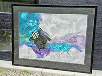 Full view of framed abstract mixed media painting with dominant turquoise, purple, grey, and black colors with metallic gold accents