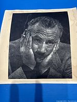 Front view of photogravure print showing John Steinbeck portrait with visible paper discoloration and stains around edges.