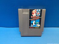 Front view of gray Nintendo game cartridge with label showcasing Super Mario Bros and Duck Hunt graphics.
