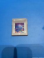 Nintendo Gameboy Tetris game cartridge shown on blue background with clear view of front label.