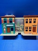 Wide shot of the two building facades and backdrop panel showing Sesame Street scene