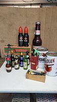 Full lot overview showing Old Style beer case, Red Army bottles, assorted beer bottles, mini kegs, and bottle openers box.