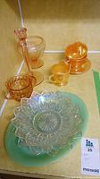 Full lot showing all glassware items including cups, saucers, candy dishes, candlestick and serving plates.