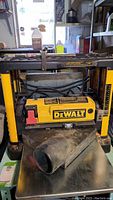 Front view of Dewalt DW733 planer showing housing, DeWalt logo and attached dust chute