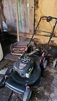 Craftsman electric lawn mower and vintage manual lawnmower together showing overall view and condition.